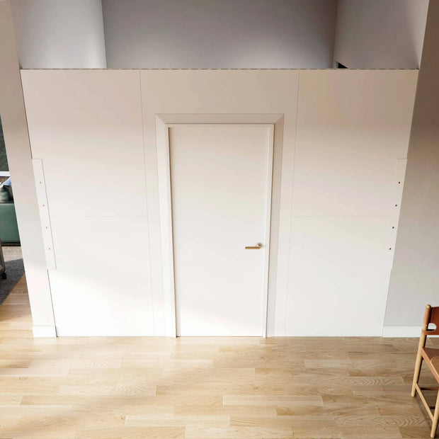 A Modular partition wall room divider with a swing door closing off a space with extra height