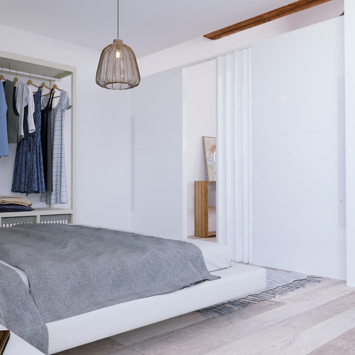 white modern guest bedroom with hardwood floors boho furniture and a modular partition wall with an accordion door