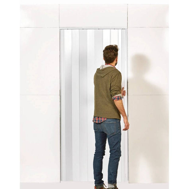 Man opening blinds on door in L shaped everpanel L shaped wall door kit