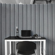Grey Versipanel acoustical room divider in front of desk with laptop and recording equipment